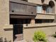 Exterior view of condo featuring a private balcony, gated patio, and lush landscaping at 700 E Mesquite Cir # N125, Tempe, AZ 85288