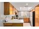 Well-lit kitchen with wooden cabinets, stainless steel appliances, and white countertops at 700 E Mesquite Cir # N125, Tempe, AZ 85288