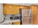 Functional kitchen area features stainless steel appliances, including a refrigerator and microwave, alongside ample cabinet space at 700 E Mesquite Cir # N125, Tempe, AZ 85288