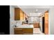 Bright kitchen with wood cabinets, stainless steel appliances, and skylight at 700 E Mesquite Cir # N125, Tempe, AZ 85288