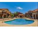 Community pool with lounge chairs and beautiful building surroundings at 700 E Mesquite Cir # N125, Tempe, AZ 85288