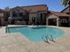 Community pool surrounded by lounge chairs offering a refreshing escape for residents at 700 E Mesquite Cir # N125, Tempe, AZ 85288