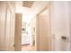 Well-lit hallway leading to a clean and functional bathroom at 7009 E Acoma Dr # 1160, Scottsdale, AZ 85254