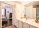 Bright bathroom featuring a vanity with white cabinets and easy access to the Primary bedroom at 7009 E Acoma Dr # 1160, Scottsdale, AZ 85254