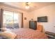 Bright bedroom featuring a ceiling fan, balcony access, and a comfortable king-sized bed at 7009 E Acoma Dr # 1160, Scottsdale, AZ 85254