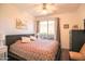 Cozy bedroom featuring a ceiling fan, balcony access, and a comfortable king-sized bed at 7009 E Acoma Dr # 1160, Scottsdale, AZ 85254