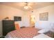 Bedroom with king bed, dresser, ceiling fan and ensuite bathroom at 7009 E Acoma Dr # 1160, Scottsdale, AZ 85254