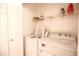 Efficient laundry room with washer, dryer, and overhead storage, optimizing space and convenience at 7009 E Acoma Dr # 1160, Scottsdale, AZ 85254