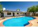 Backyard view of pool featuring covered patio and solar panels on home at 736 N Meadows Dr, Chandler, AZ 85224