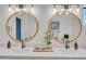 Bathroom featuring a double vanity with round mirrors, modern fixtures, and white countertops at 736 N Meadows Dr, Chandler, AZ 85224
