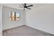 Bright bedroom features neutral carpet, ceiling fan, and a large window with neighborhood views at 736 N Meadows Dr, Chandler, AZ 85224