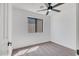A carpeted bedroom with white walls featuring a large window and ceiling fan at 736 N Meadows Dr, Chandler, AZ 85224