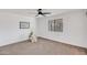 A simple bedroom, with a ceiling fan, window and minimalist decor with carpeted floor at 736 N Meadows Dr, Chandler, AZ 85224
