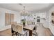 Bright and airy dining area with modern chandelier connects to the kitchen with stainless appliances at 736 N Meadows Dr, Chandler, AZ 85224