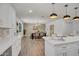 Bright dining area with modern chandelier, wood floors, and updated lighting near a kitchen island at 736 N Meadows Dr, Chandler, AZ 85224