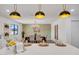 Bright kitchen with white cabinets, stainless steel appliances, island with seating, and a dining area at 736 N Meadows Dr, Chandler, AZ 85224