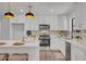 Bright modern kitchen with white cabinets, stainless steel appliances, island with seating at 736 N Meadows Dr, Chandler, AZ 85224
