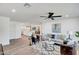 Open-concept living room featuring a comfortable sofa, leather chairs, modern rug and ceiling fan at 736 N Meadows Dr, Chandler, AZ 85224