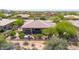 Expansive aerial view of a luxurious home showcasing its desert landscape and picturesque neighborhood at 7500 E Pontebella Dr, Scottsdale, AZ 85266