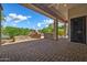 Inviting covered back patio with a stone pizza oven and column supports, ideal for outdoor entertaining at 7500 E Pontebella Dr, Scottsdale, AZ 85266