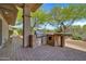 Outdoor patio featuring a built-in stone BBQ area with brick flooring and counter seating at 7500 E Pontebella Dr, Scottsdale, AZ 85266