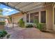 Charming back patio with decorative stone flooring, a pergola, and lush landscaping at 7500 E Pontebella Dr, Scottsdale, AZ 85266
