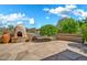 Outdoor patio with a stone fireplace and a built-in bench, perfect for relaxing outside at 7500 E Pontebella Dr, Scottsdale, AZ 85266