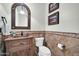Bathroom with a unique copper sink, rustic wood vanity, and decorative tile accents at 7500 E Pontebella Dr, Scottsdale, AZ 85266