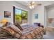Bedroom featuring a large window with a backyard view, plus a ceiling fan for added comfort at 7500 E Pontebella Dr, Scottsdale, AZ 85266
