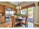 Cozy dining area with stainless steel refrigerator, wooden table and chairs, and natural light at 7500 E Pontebella Dr, Scottsdale, AZ 85266