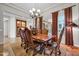 Elegant dining room with a large wooden table, comfortable chairs, and ornate chandelier at 7500 E Pontebella Dr, Scottsdale, AZ 85266