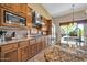 Well-equipped kitchen featuring stainless steel appliances and granite countertops and backsplash at 7500 E Pontebella Dr, Scottsdale, AZ 85266