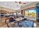 Open-concept living room with a spacious layout, large windows, and access to the kitchen area at 7500 E Pontebella Dr, Scottsdale, AZ 85266