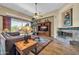 Cozy living room with fireplace, media center and lots of light from a big window at 7500 E Pontebella Dr, Scottsdale, AZ 85266
