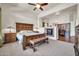 Spacious main bedroom with a cozy fireplace and a comfortable wooden bed and furniture at 7500 E Pontebella Dr, Scottsdale, AZ 85266