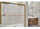 The bathroom is bright with a glass enclosed shower, a wood vanity, and tile floor at 7500 E Pontebella Dr, Scottsdale, AZ 85266
