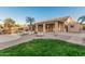 Backyard featuring lush lawn, gravel, mature trees and access to the pool provides outdoor living space at 8220 W Mariposa Grande Ln, Peoria, AZ 85383