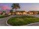 Lush backyard with grassy area, mature trees, gravel, and stamped concrete accents create a tranquil retreat at 8220 W Mariposa Grande Ln, Peoria, AZ 85383