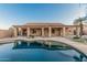 Backyard with pool, covered patio, gravel landscaping, and mature trees creates a relaxing outdoor retreat at 8220 W Mariposa Grande Ln, Peoria, AZ 85383