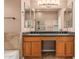 Bathroom showcasing dual vanities, granite countertops, and views of the glass-enclosed shower at 8220 W Mariposa Grande Ln, Peoria, AZ 85383