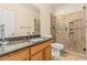 Bathroom with a single vanity, granite countertop, and a glass shower to match the rest of the room at 8220 W Mariposa Grande Ln, Peoria, AZ 85383