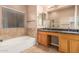 Bright bathroom showcasing a soaking tub, dual vanities, and a glass-enclosed shower at 8220 W Mariposa Grande Ln, Peoria, AZ 85383