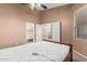 Bedroom with a ceiling fan, walk-in closet, neutral carpet, and a mattress on the bed frame at 8220 W Mariposa Grande Ln, Peoria, AZ 85383