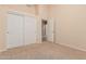 Bedroom featuring sliding door closet, carpet, and neutral walls to match the rest of the room at 8220 W Mariposa Grande Ln, Peoria, AZ 85383