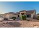 Home featuring a spacious garage, desert landscaping with shrubs and gravel at 8220 W Mariposa Grande Ln, Peoria, AZ 85383