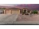 Charming home featuring a spacious three-car garage, tile roof, and desert landscaping at 8220 W Mariposa Grande Ln, Peoria, AZ 85383