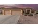 Charming home featuring a spacious three-car garage, tile roof, and desert landscaping at 8220 W Mariposa Grande Ln, Peoria, AZ 85383