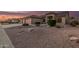 Home featuring a spacious garage, desert landscaping with shrubs and gravel at 8220 W Mariposa Grande Ln, Peoria, AZ 85383