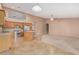 Open-concept kitchen with stainless steel appliances, island, and vaulted ceilings, ideal for cooking and gathering at 8220 W Mariposa Grande Ln, Peoria, AZ 85383