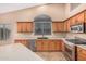Updated kitchen with stainless steel appliances, dark sink, and light countertops, offering a modern cooking experience at 8220 W Mariposa Grande Ln, Peoria, AZ 85383